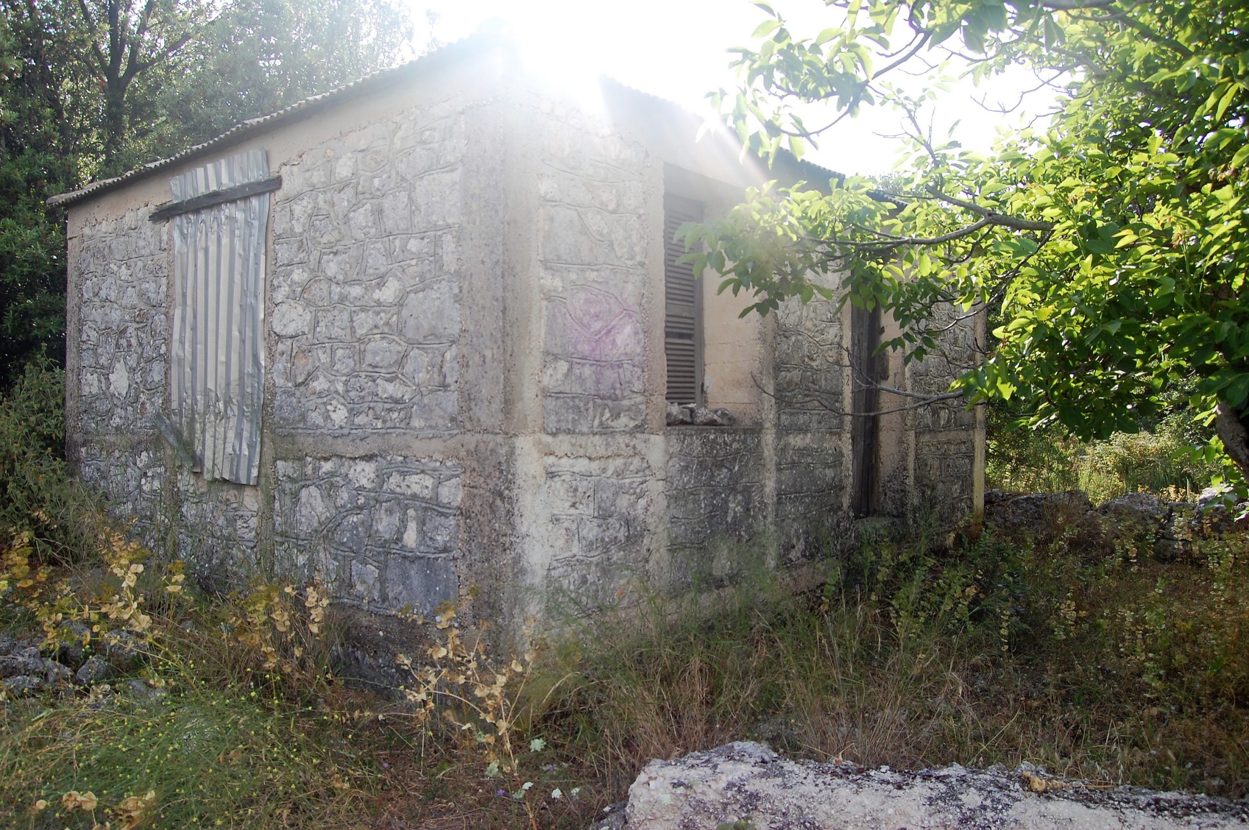 Exterior view of land with house for sale on Ithaca Greece