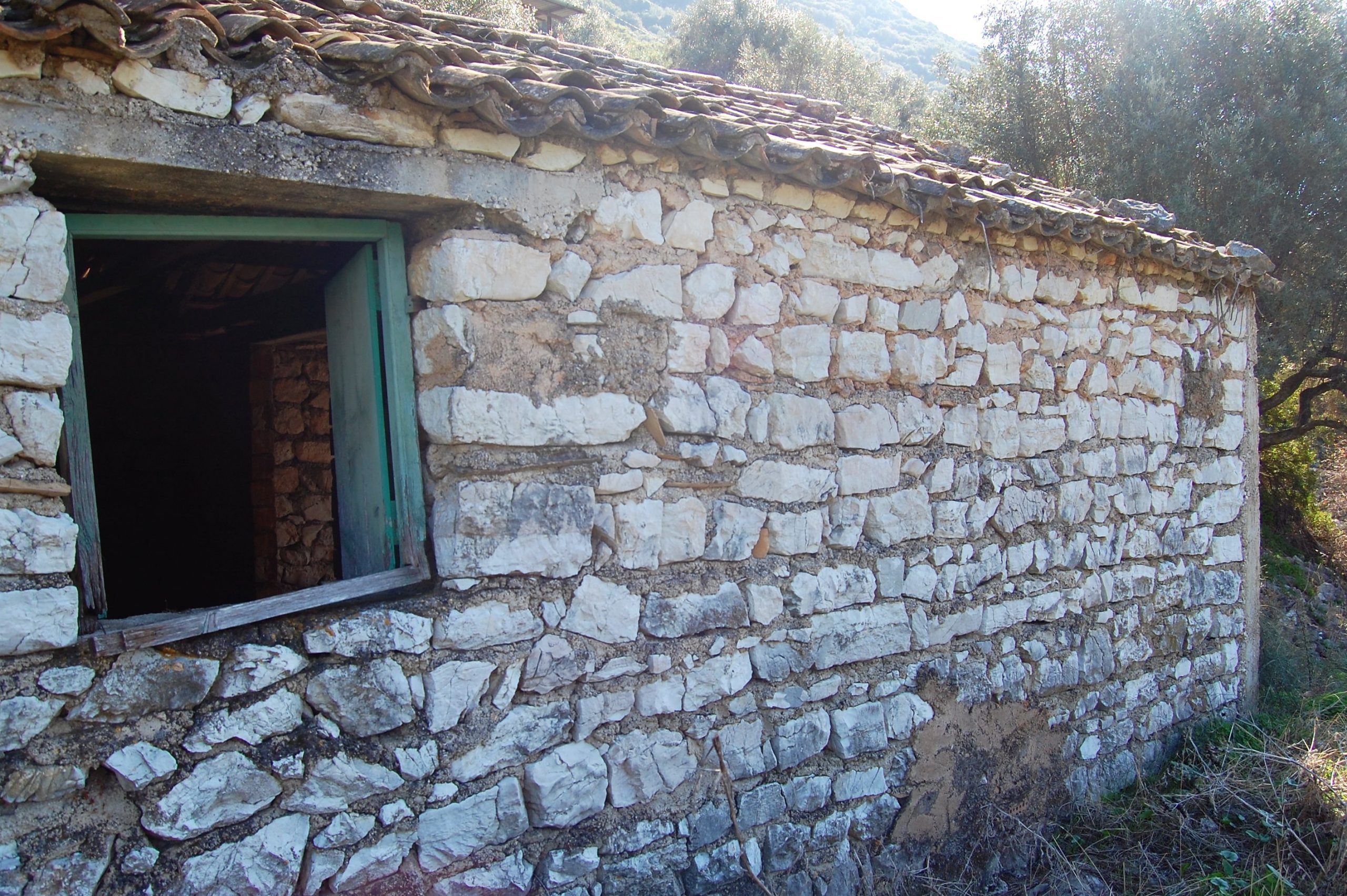 Exterior view of land with house for sale on Ithaca Greece