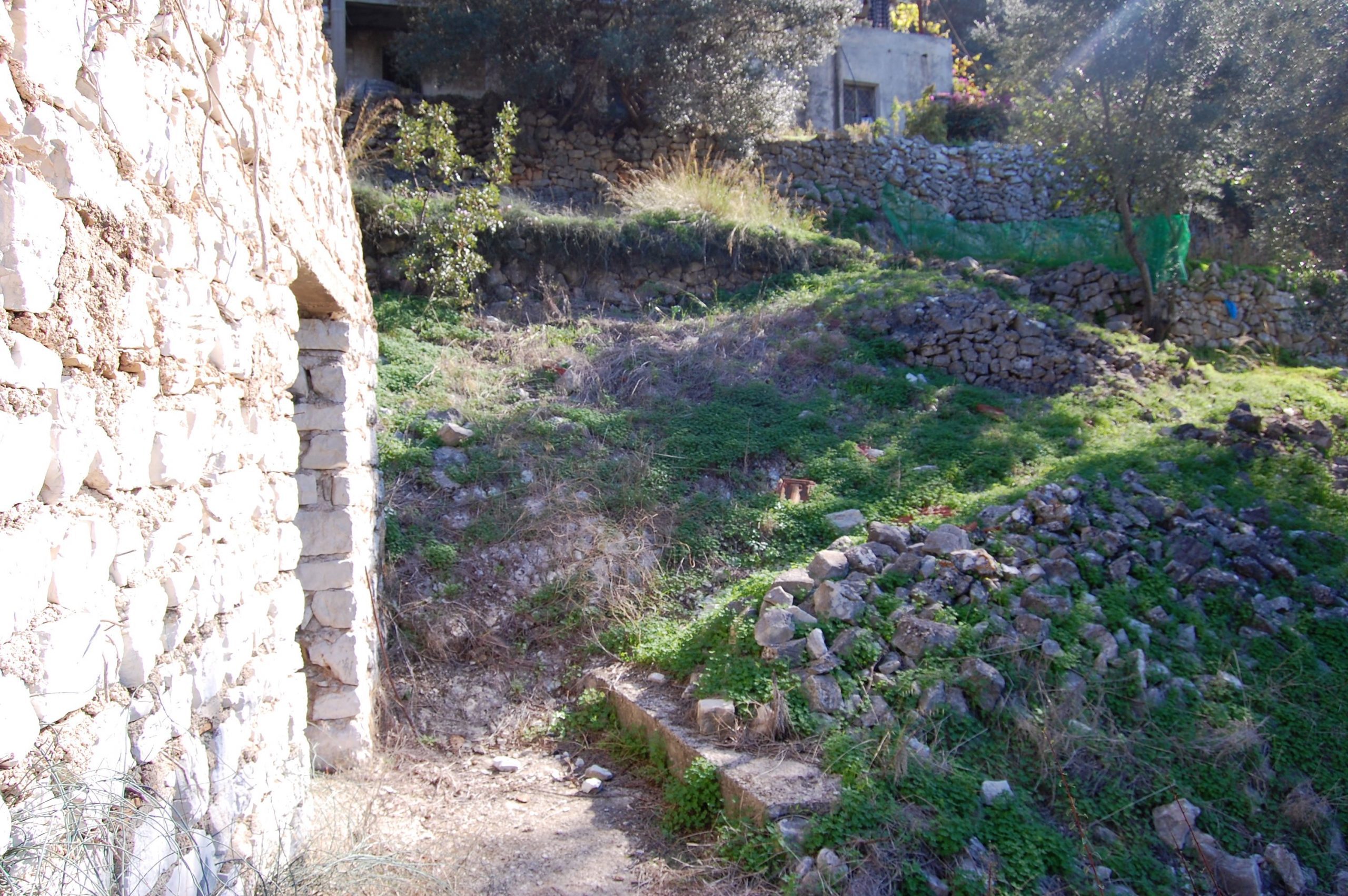 Exterior view of land with house for sale on Ithaca Greece