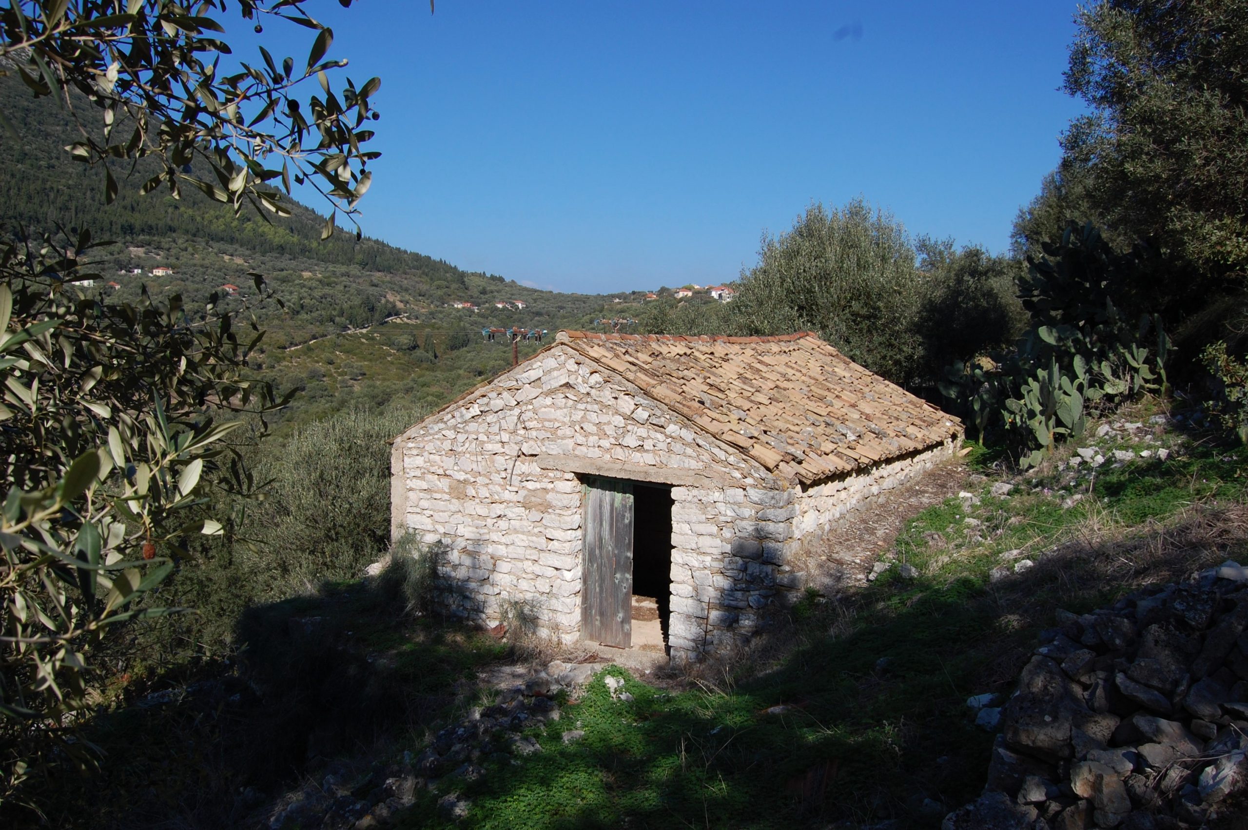 Exterior view of land with house for sale on Ithaca Greece