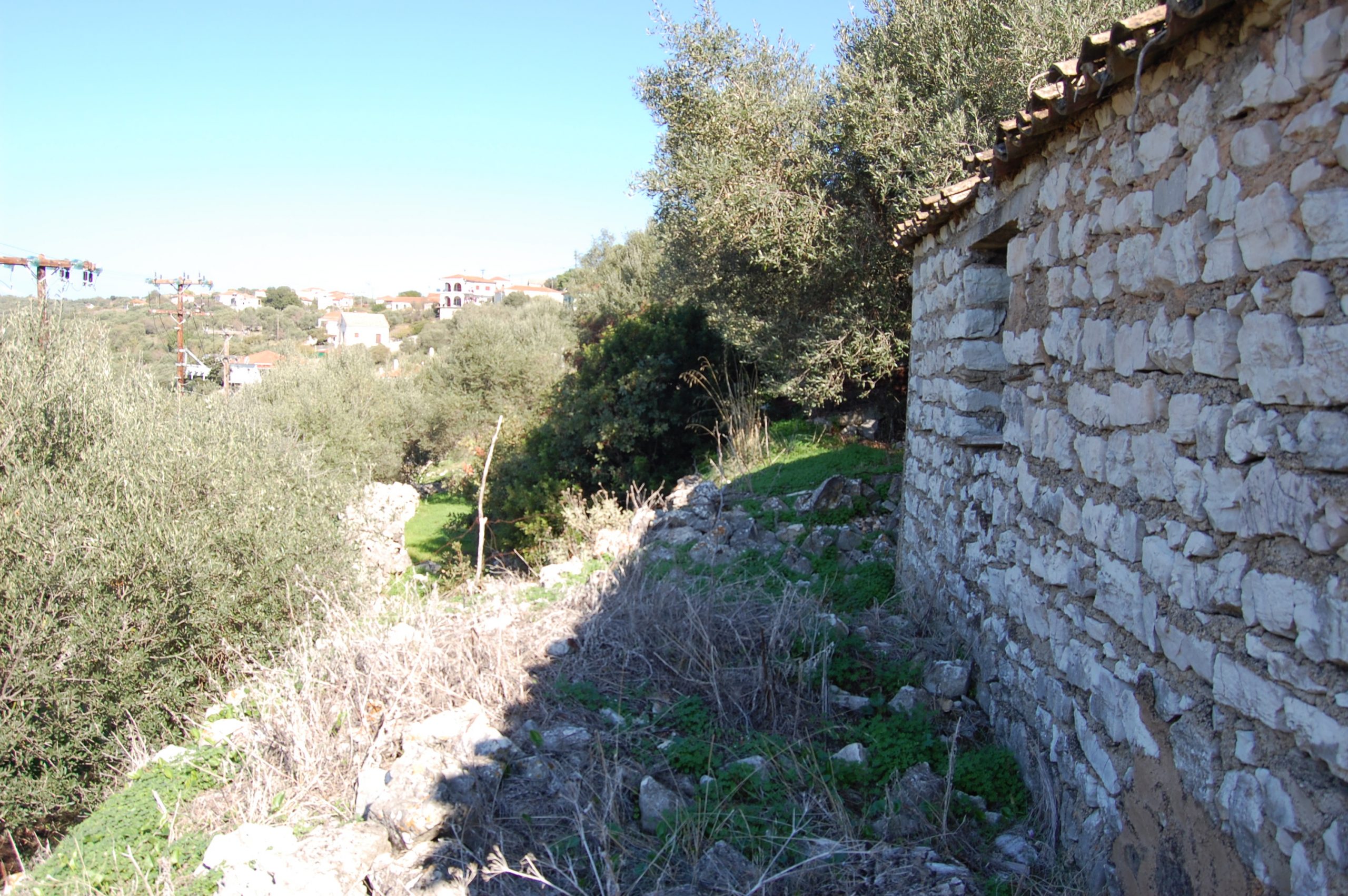 Exterior view of land with house for sale on Ithaca Greece