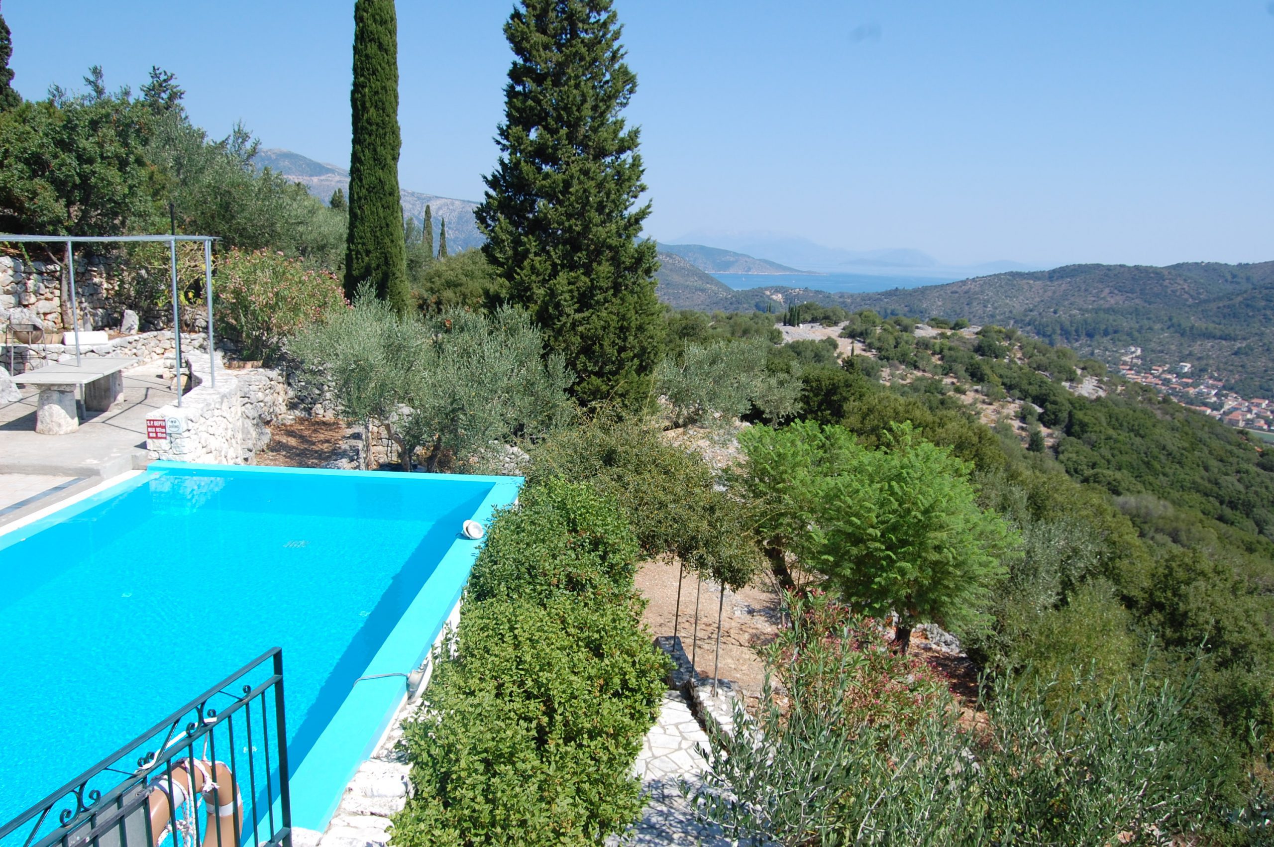 Swimming pool and stone terrace with view of property for sale in Ithaca Greece Perachori