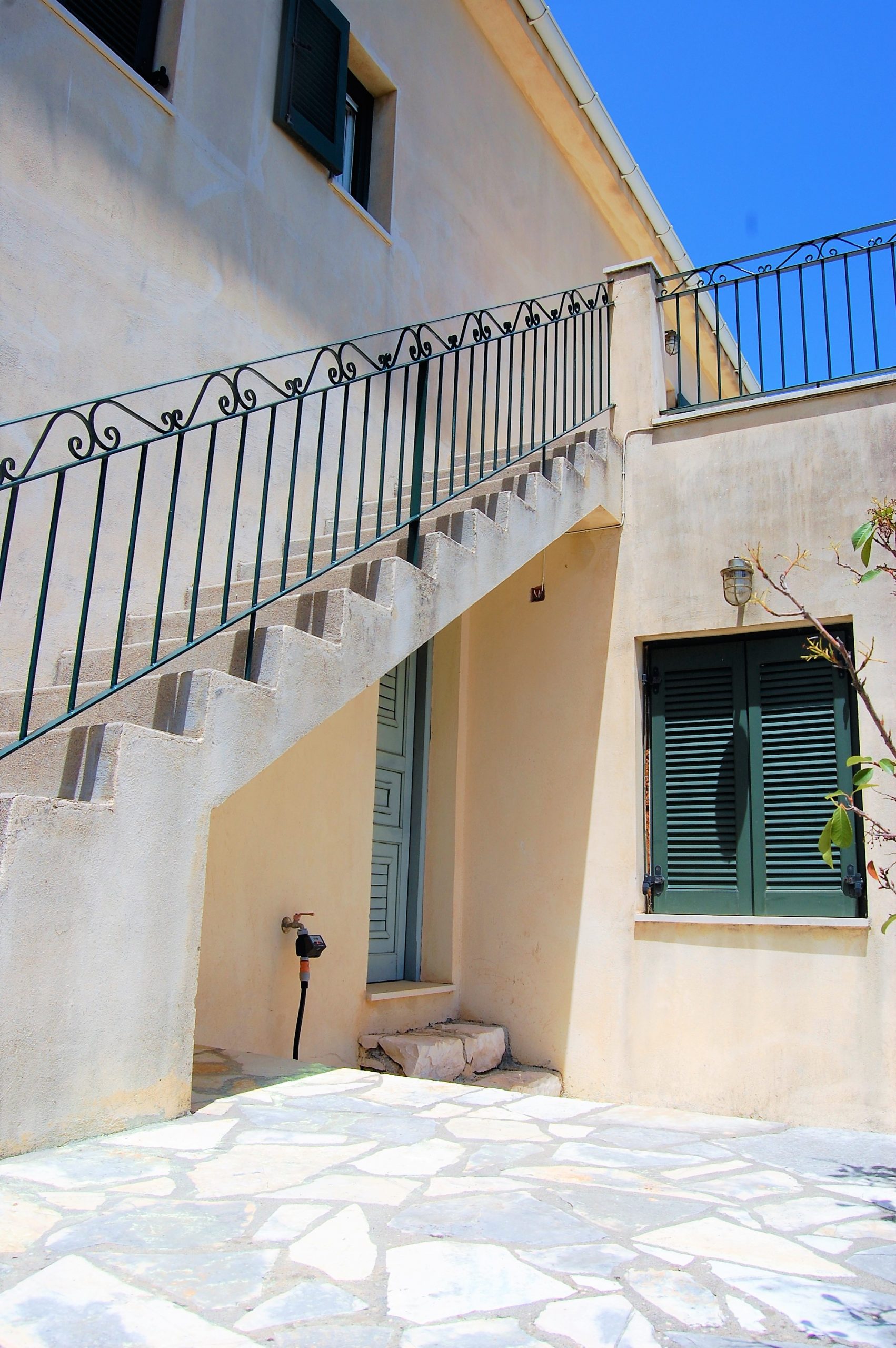 Rear outside staircase of house for sale Ithaca Greece