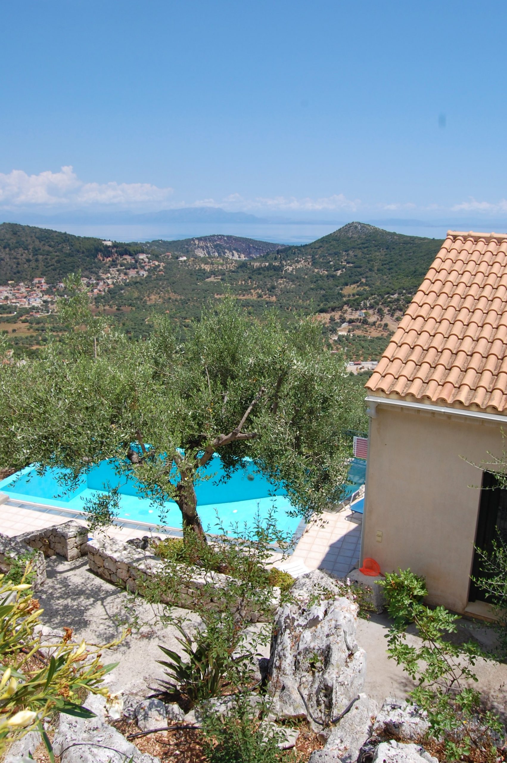 Back view of house overlooking pool of house for sale Ithaca Greece