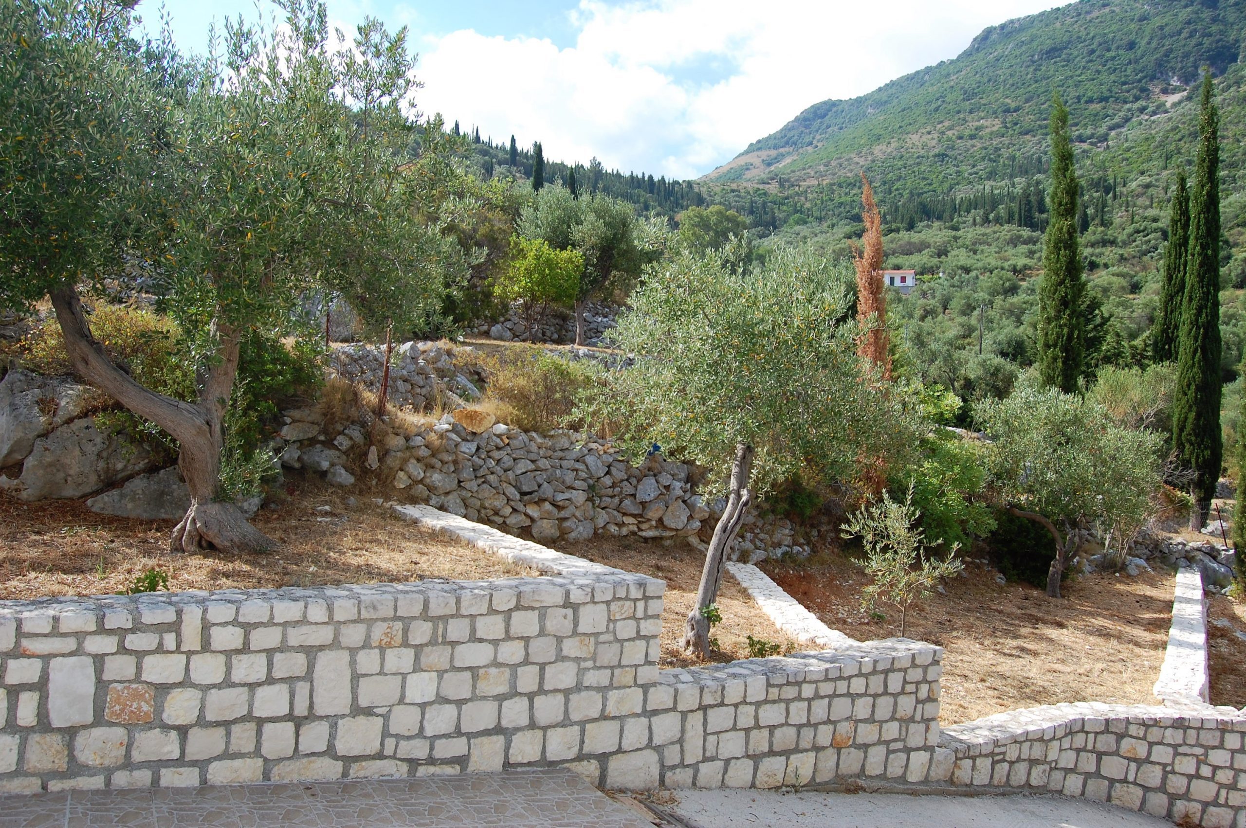 Outside stone walls of terraced area of property for sale in Ithaca Greece Vathi
