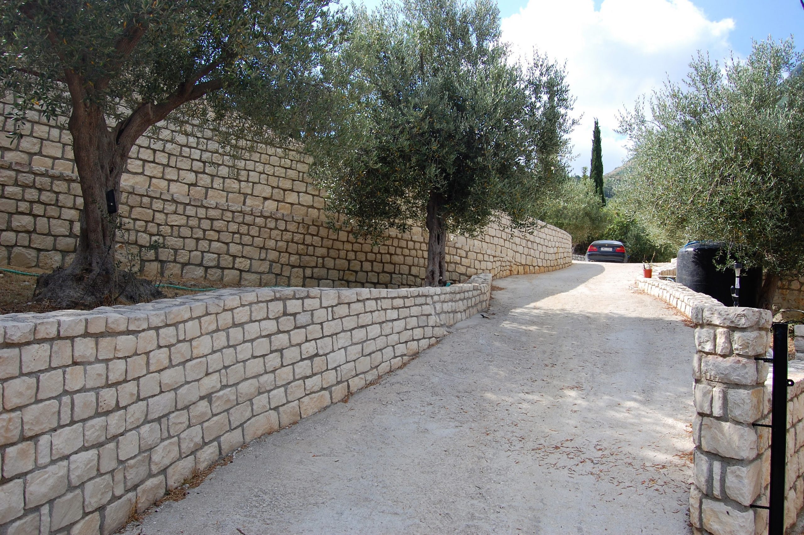 Front entrance driveway with terraced levels of property for sale in Ithaca Greece Vathi
