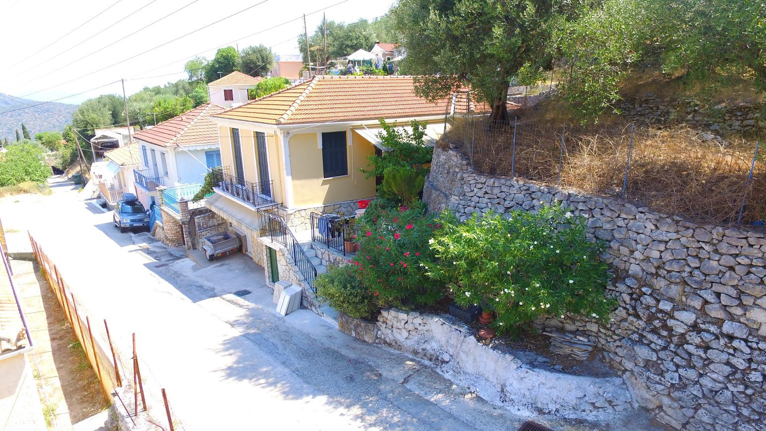 Aerial view street and entrance of house for sale on Ithaca Greece, Perachori