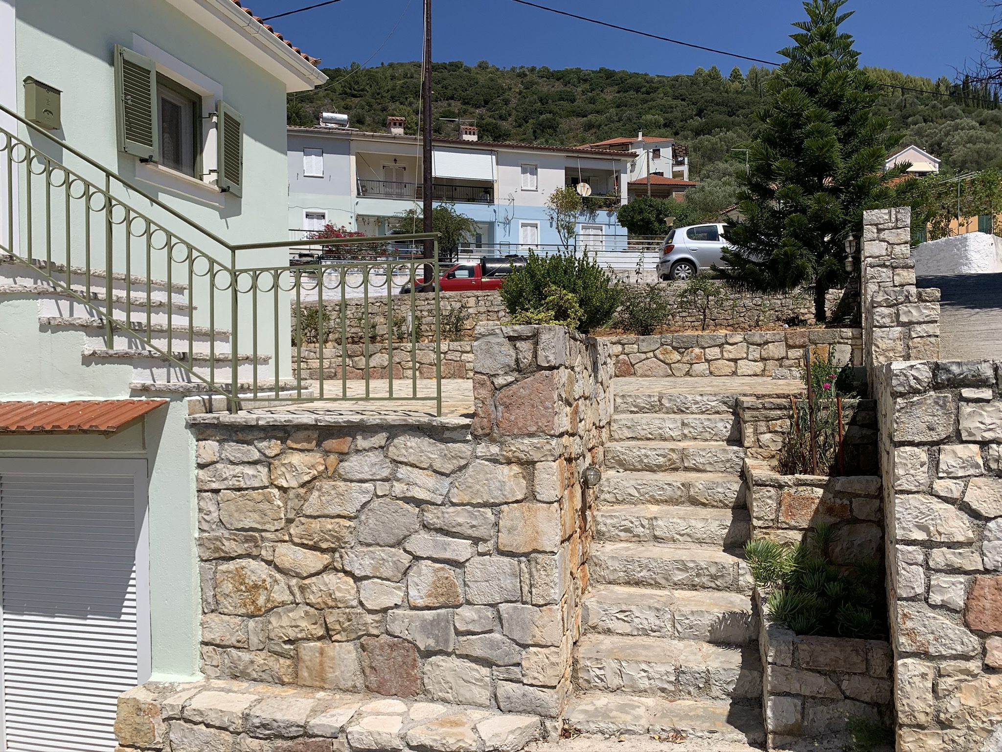 Exterior facade with stone terrace of house for sale in Ithaca Greece, Vathi