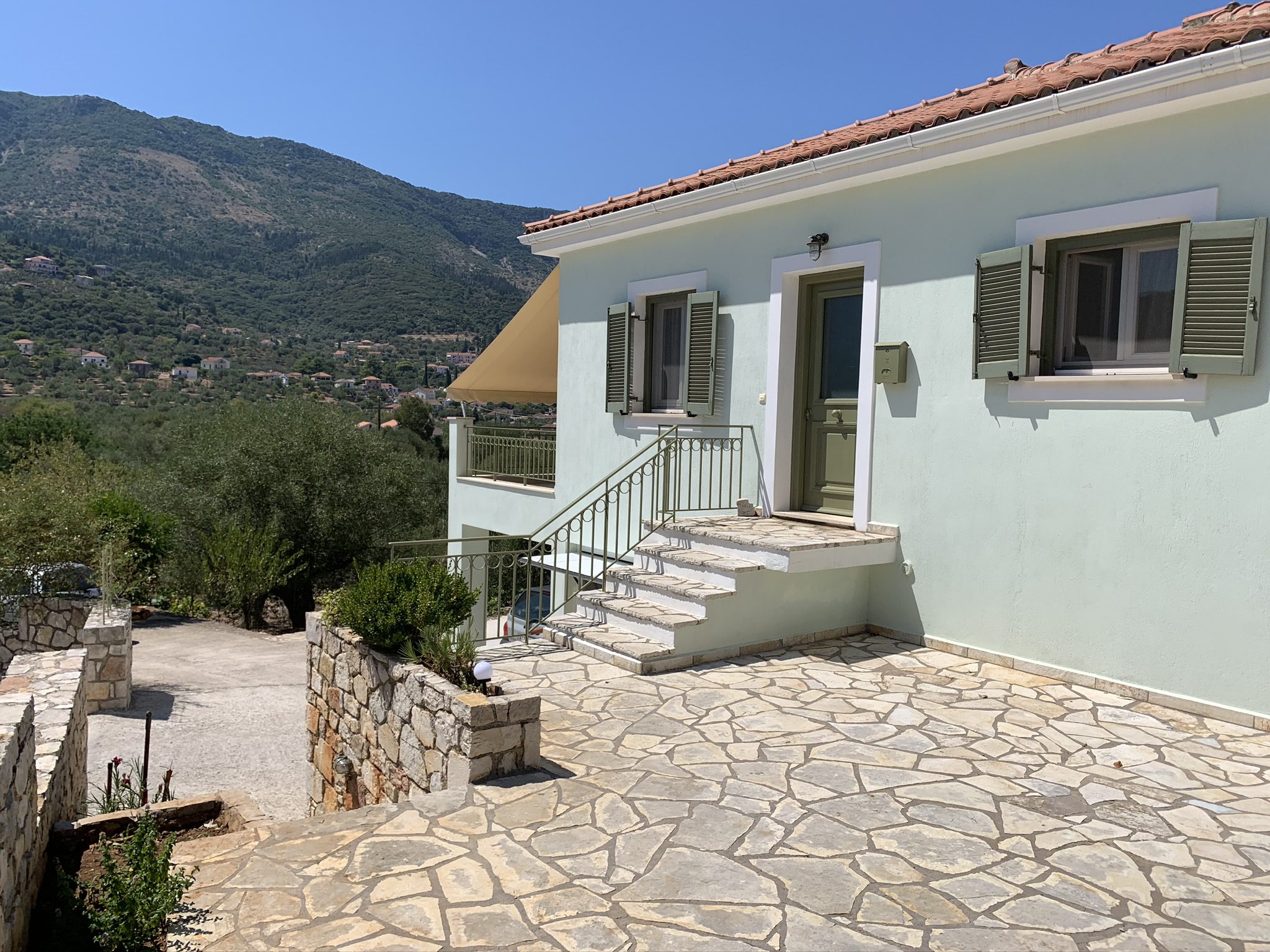 Exterior facade with stone terrace of house for sale in Ithaca Greece, Vathi