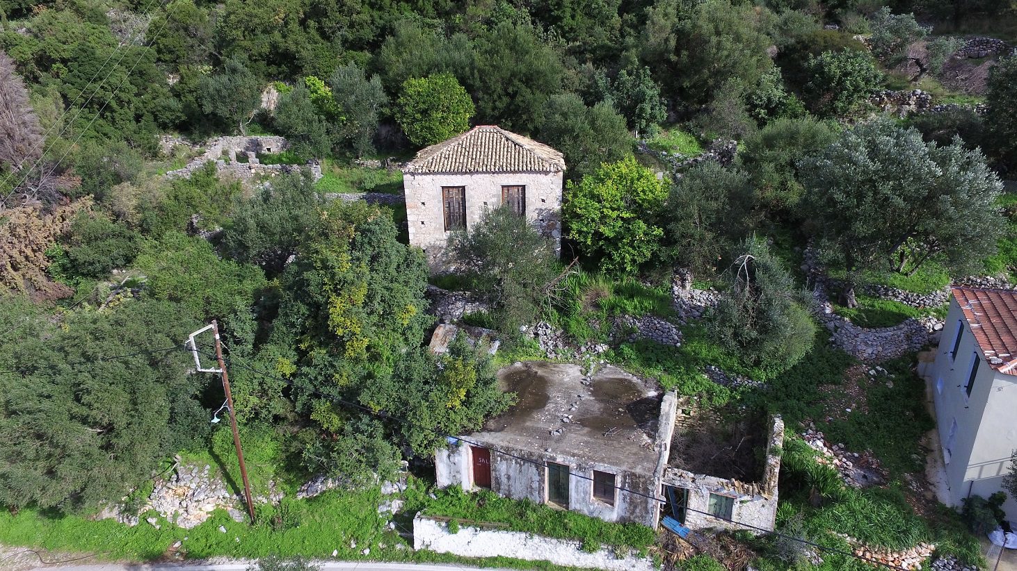 Aerial view of house with ruin for sale in Ithaca Greece Lefki