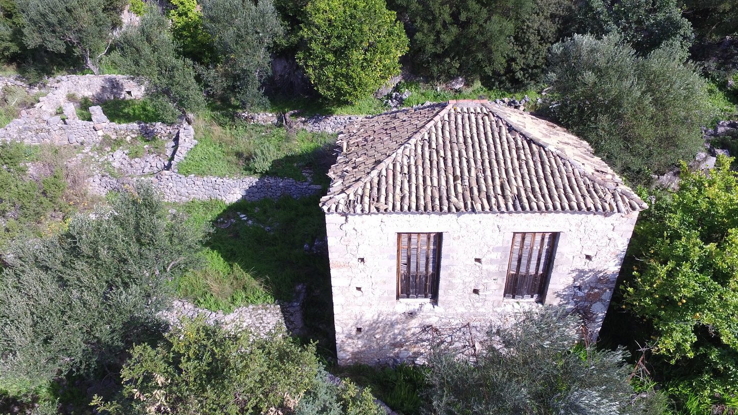 Aerial view of house with ruin for sale in Ithaca Greece Lefki