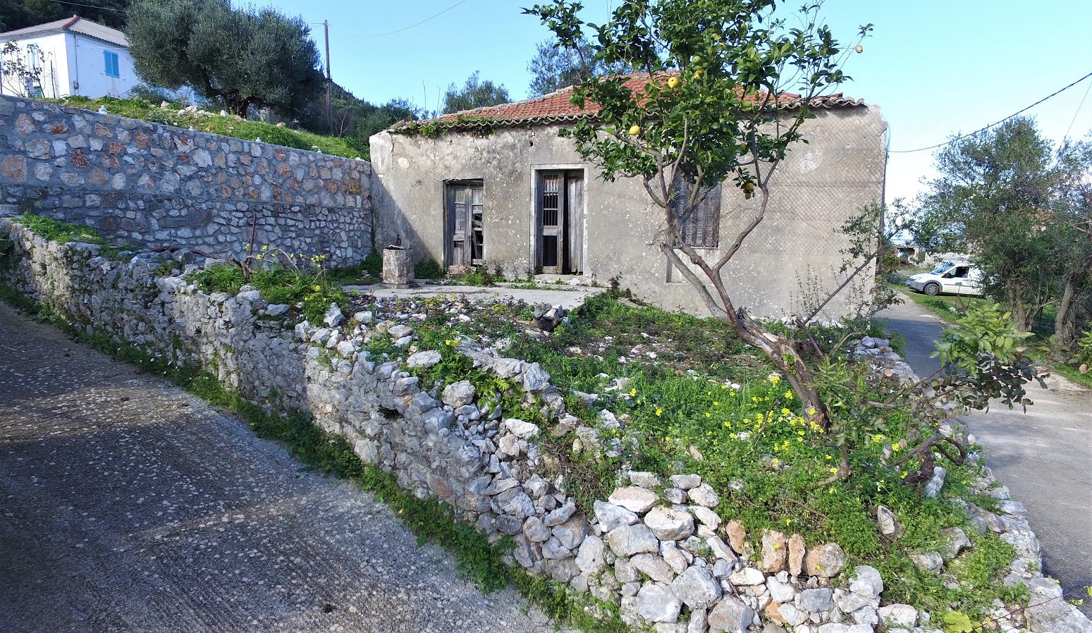Exterior facade and garden of house for sale in Ithaca Greece Kolleri