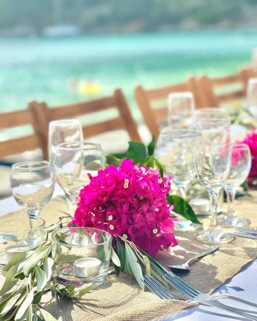 Table flower arrangement detail at beach wedding reception, Ithaca Greece