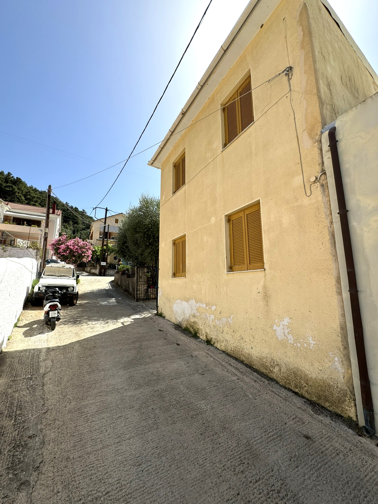 Road view of house for sale in Ithaca Greece Vathi