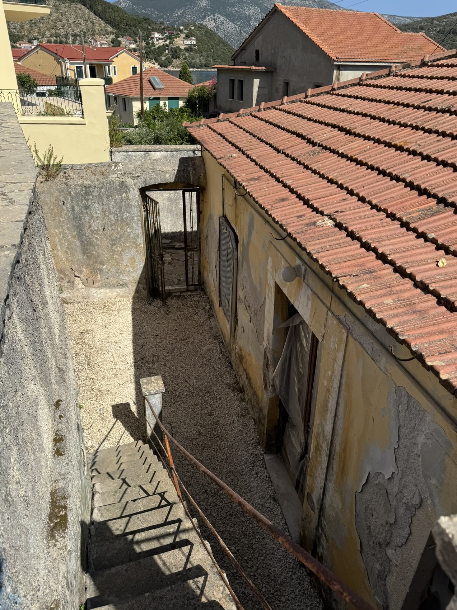 Back courtyard and stairs to terrace of house for sale in Ithaca Greece Vathi