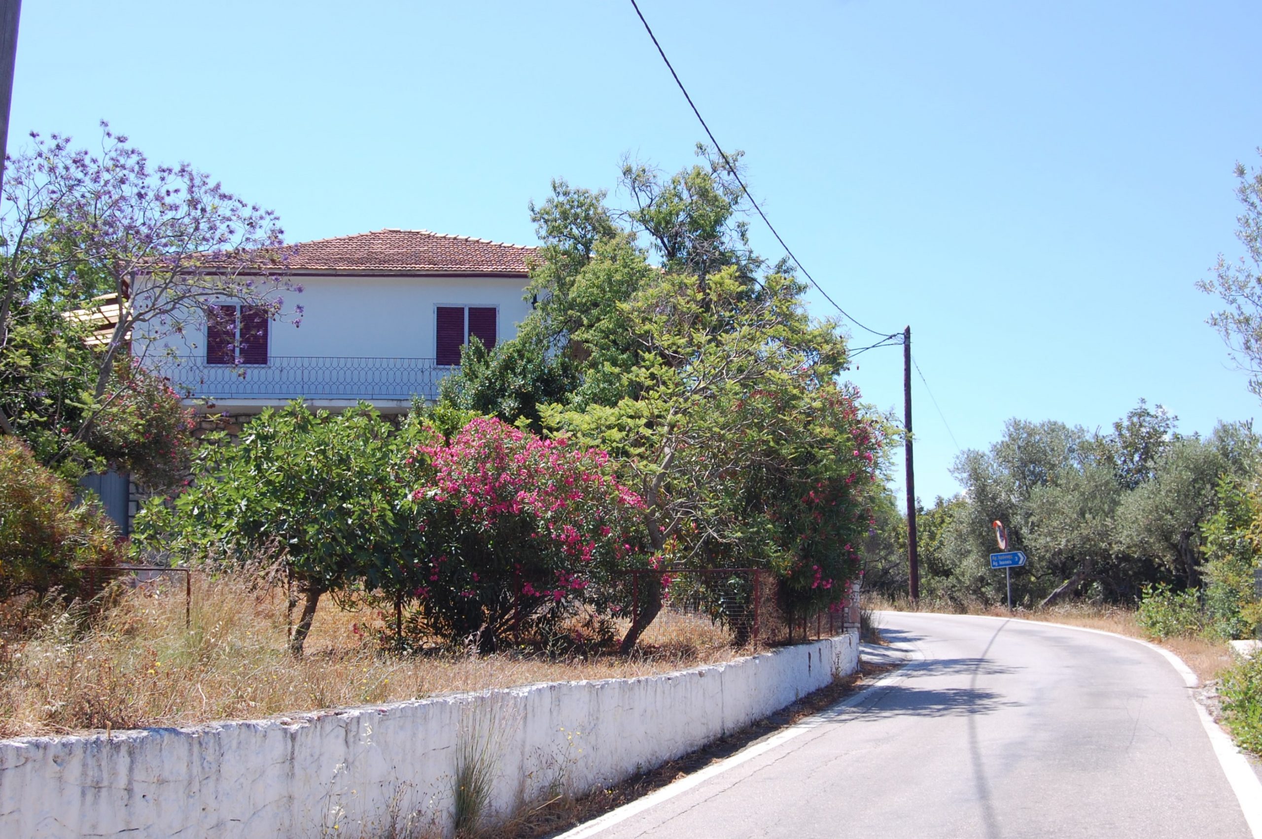 View from the street of house for sale in Ithaca Greece Lefki