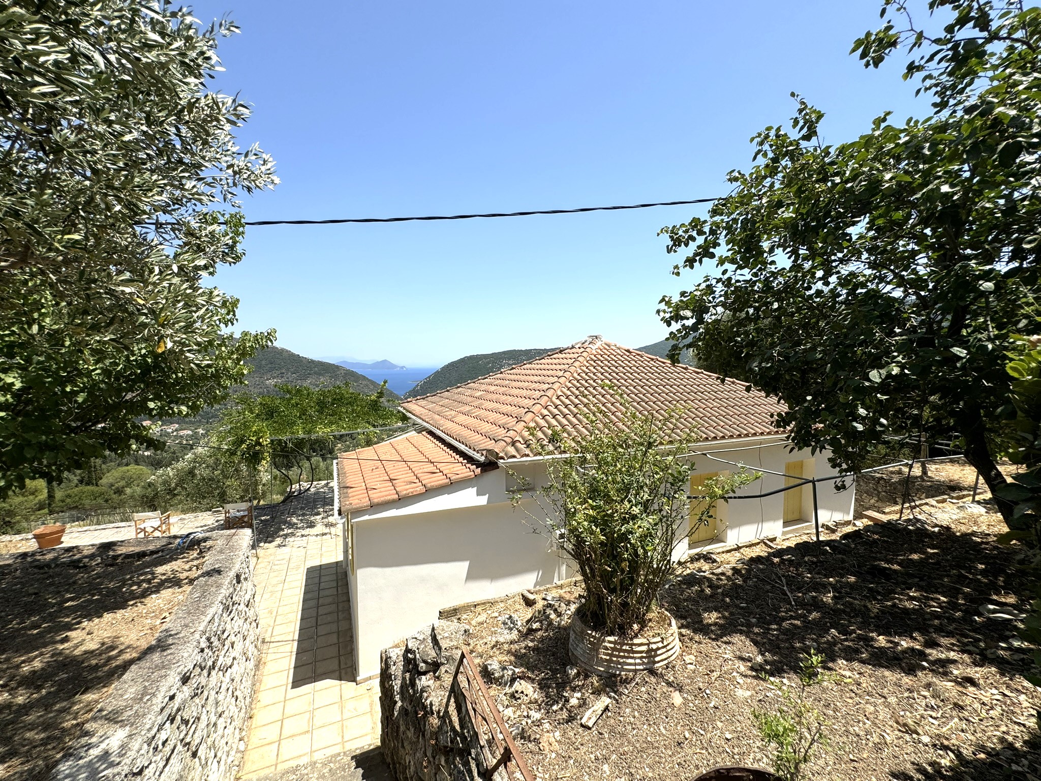 Garden and exterior of house for sale in Ithaca Greece Platrithya