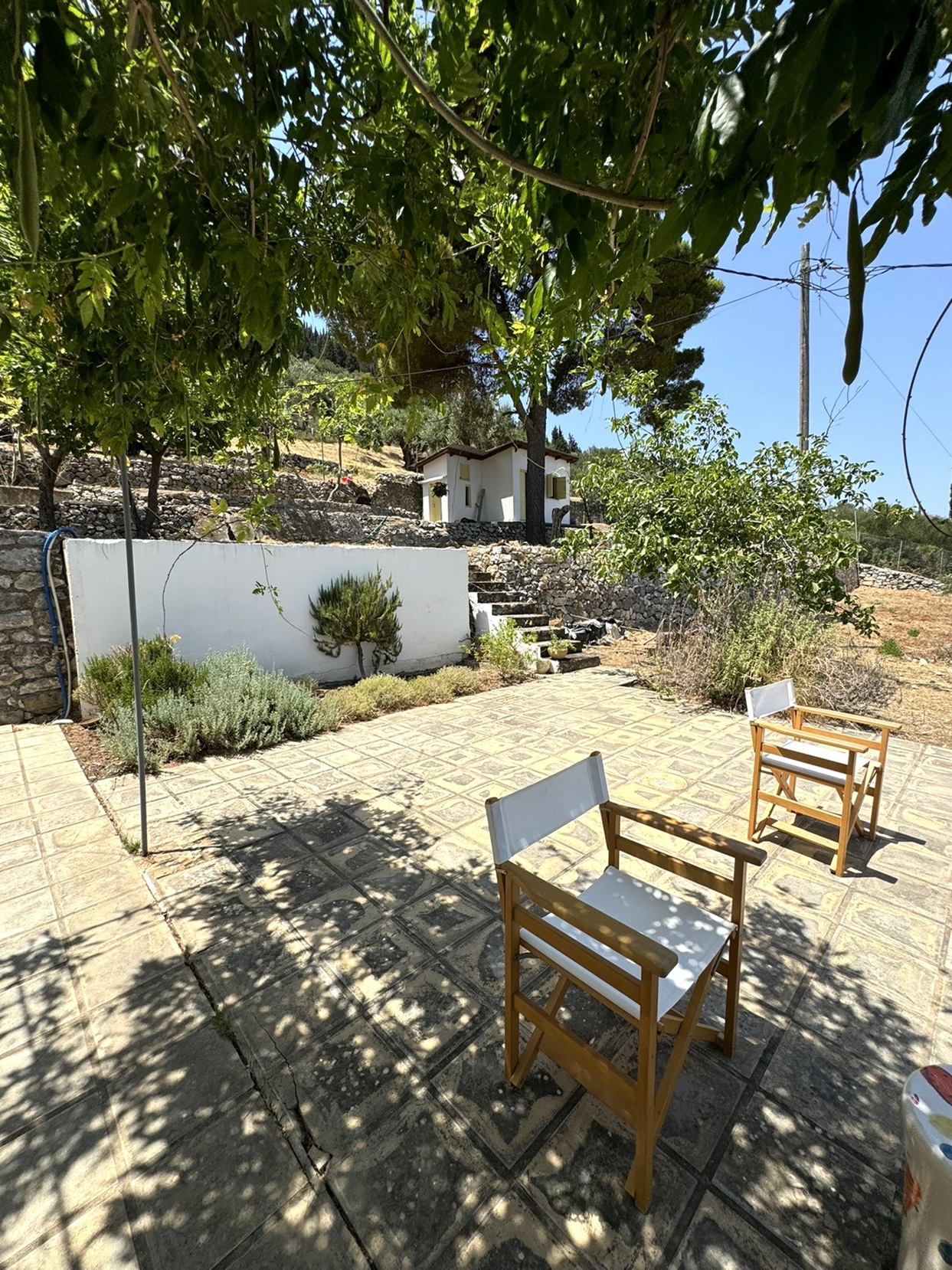 Patio and exterior of detached guesthouse of house for sale in Ithaca Greece Platrithya