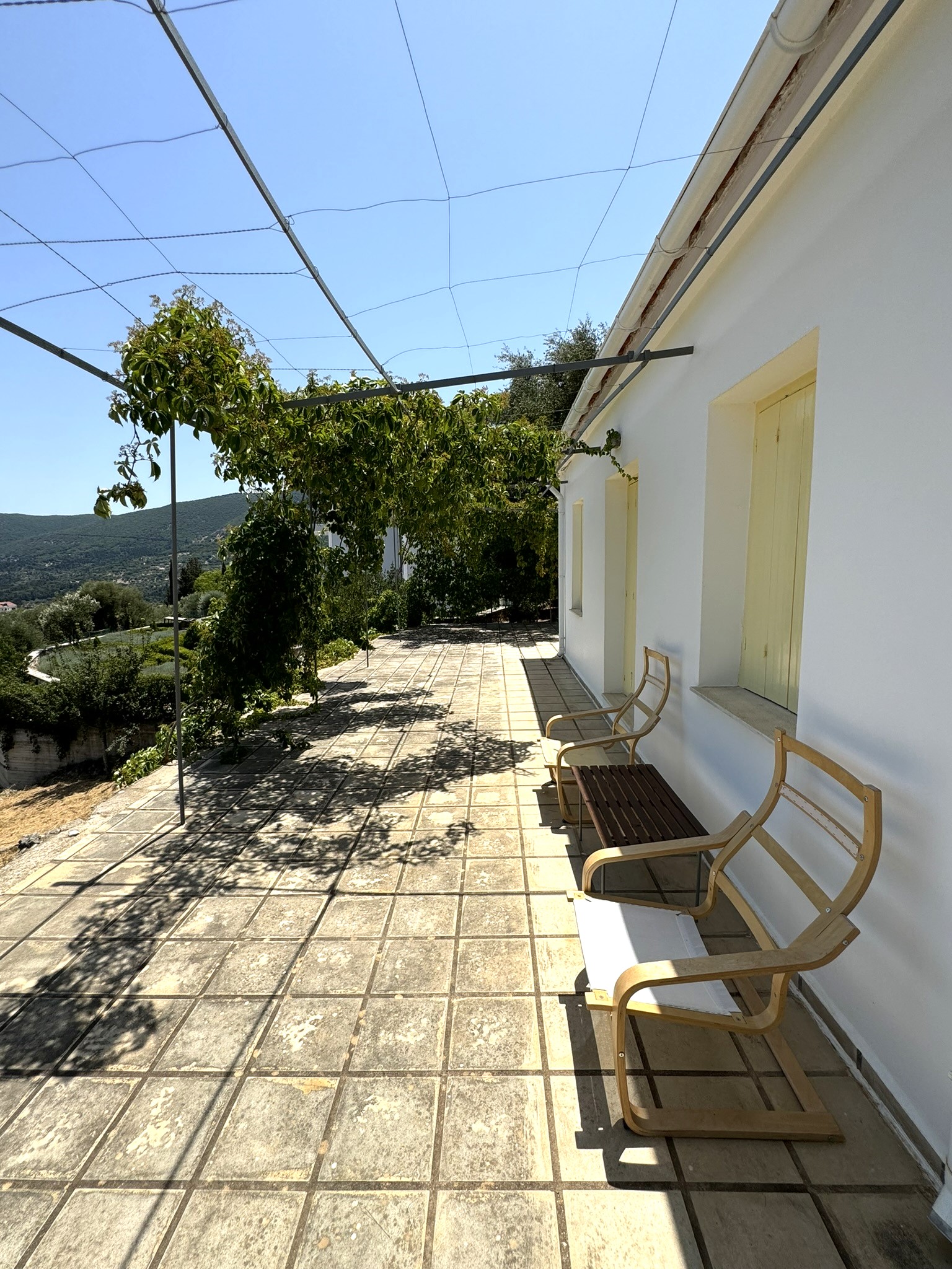 Exterior with garden furniture of house for sale in Ithaca Greece Platrithya