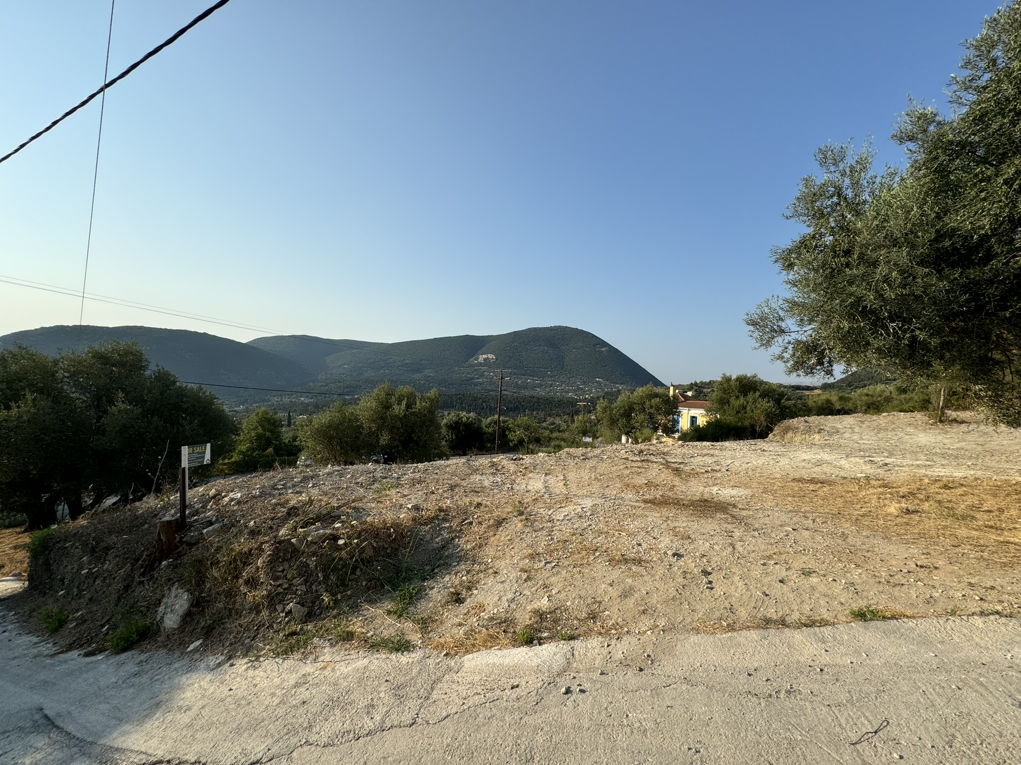 Road view of land for sale in Ithaca Greece Platrithya