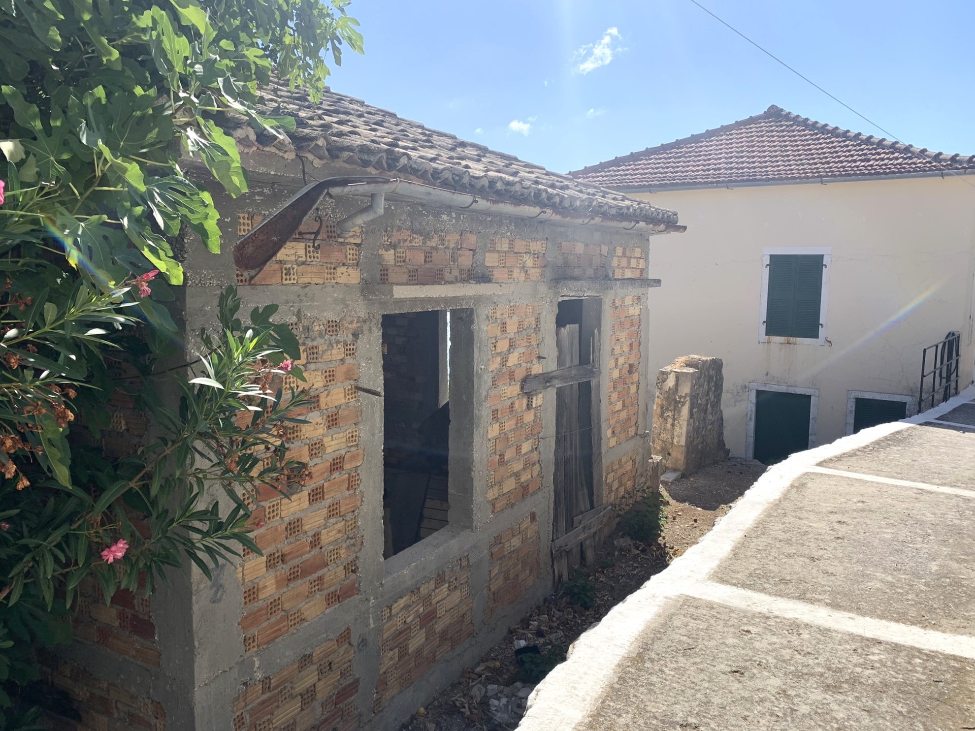 Road view of house for sale in Ithaca Greece Kioni