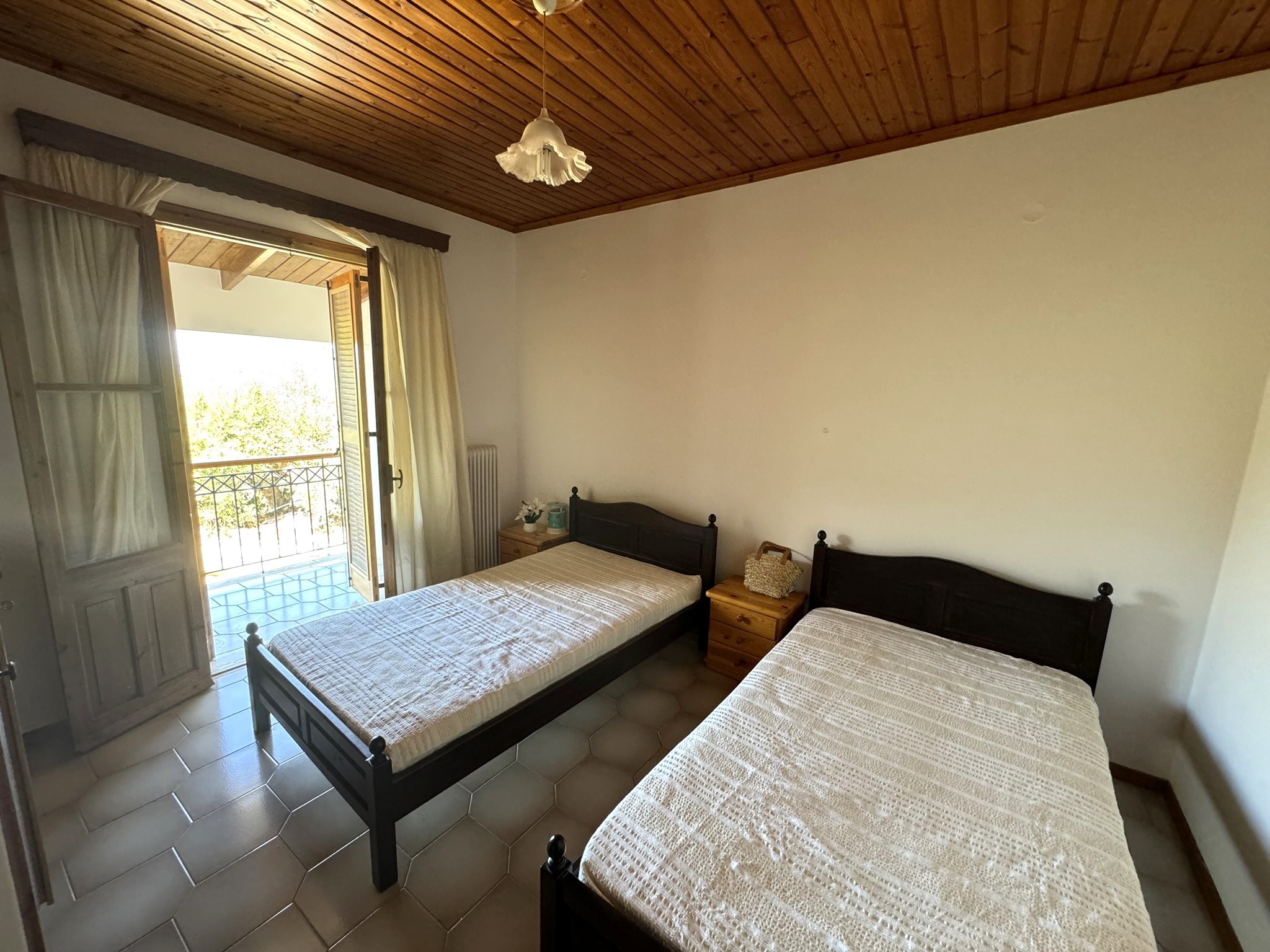 Twin bedroom with balcony of house for sale in Ithaca Greece Stavros