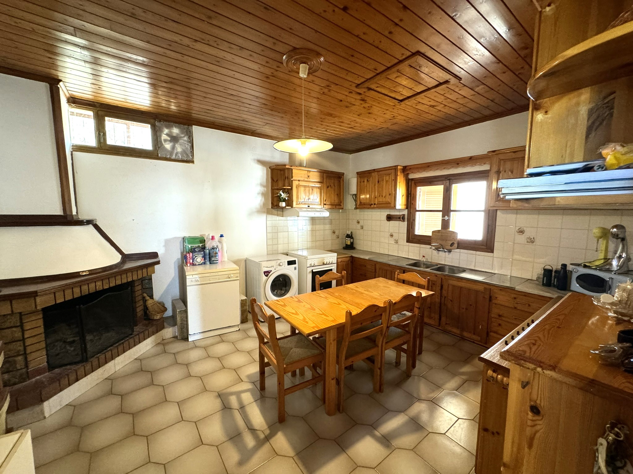 Kitchen area with fireplace of house for sale in Ithaca Greece Stavros