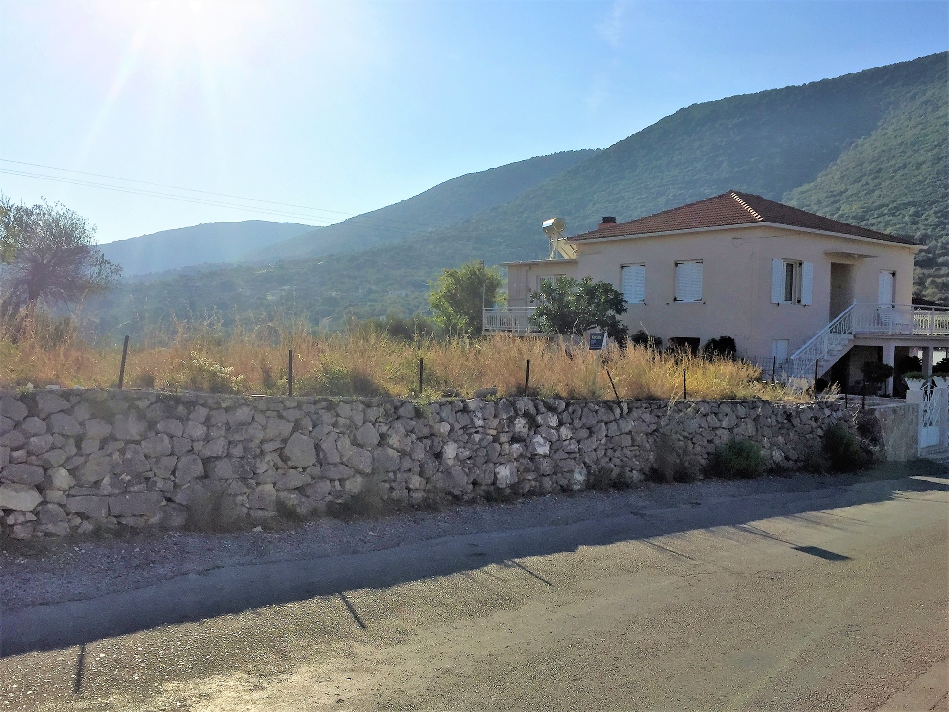 Road view of land for sale in Ithaca Greece Stavros