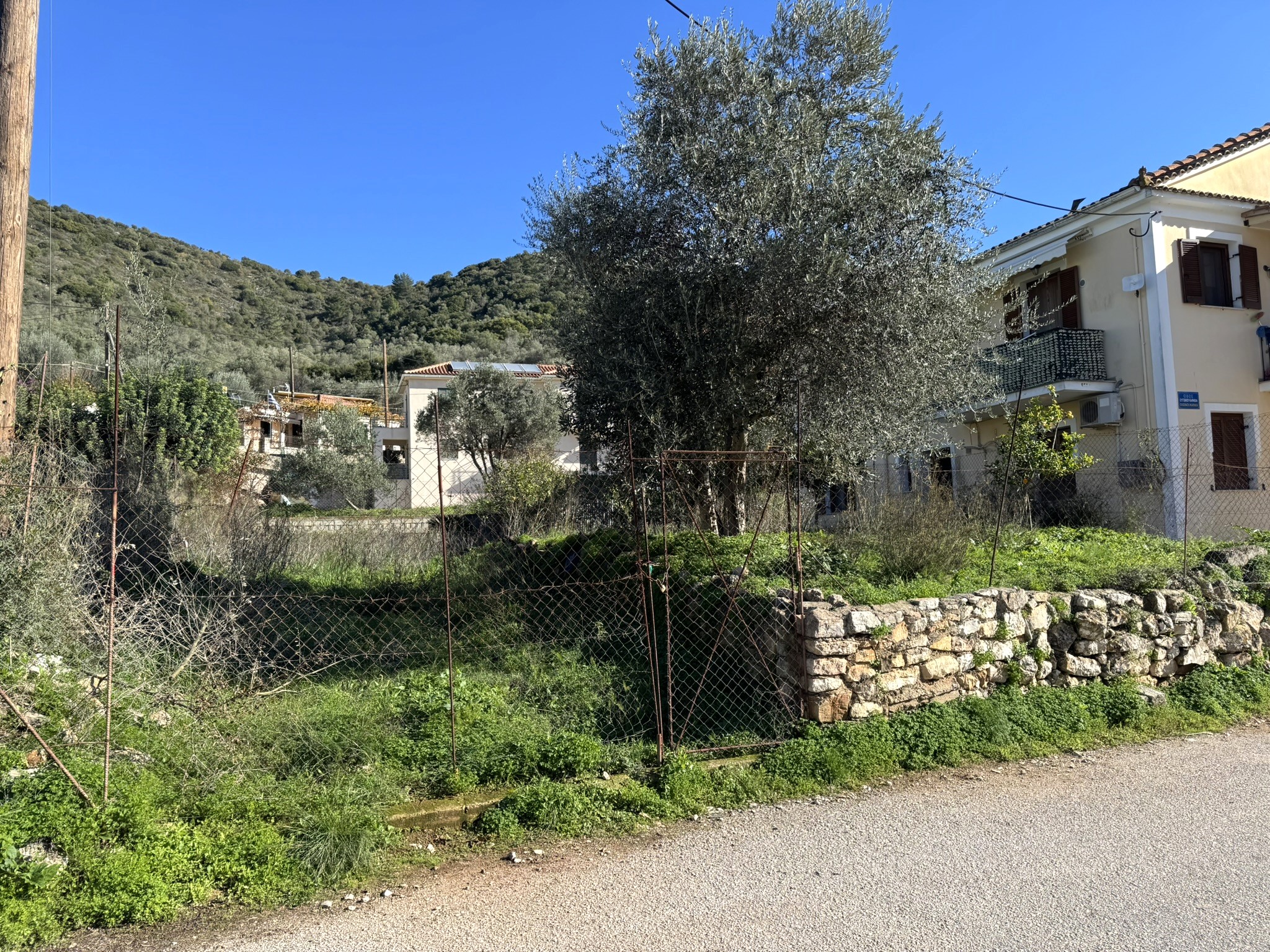 Road view of land for sale in Ithaca Greece, Vathi