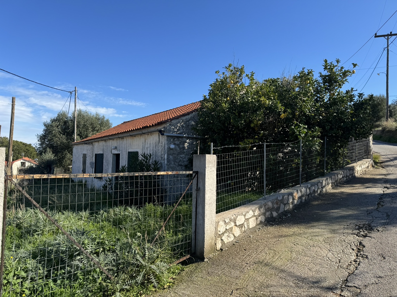 Road view of house for sale in Ithaca Greece, Stavros