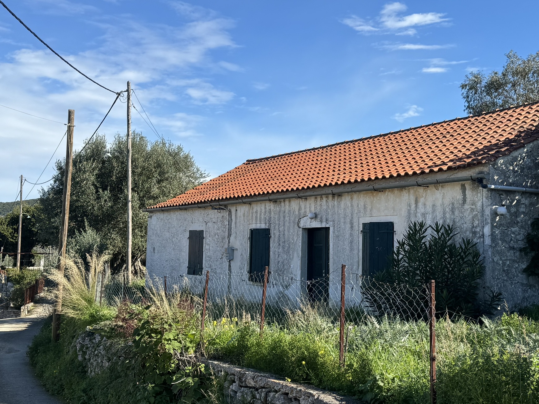Road view of house for sale in Ithaca Greece, Stavros