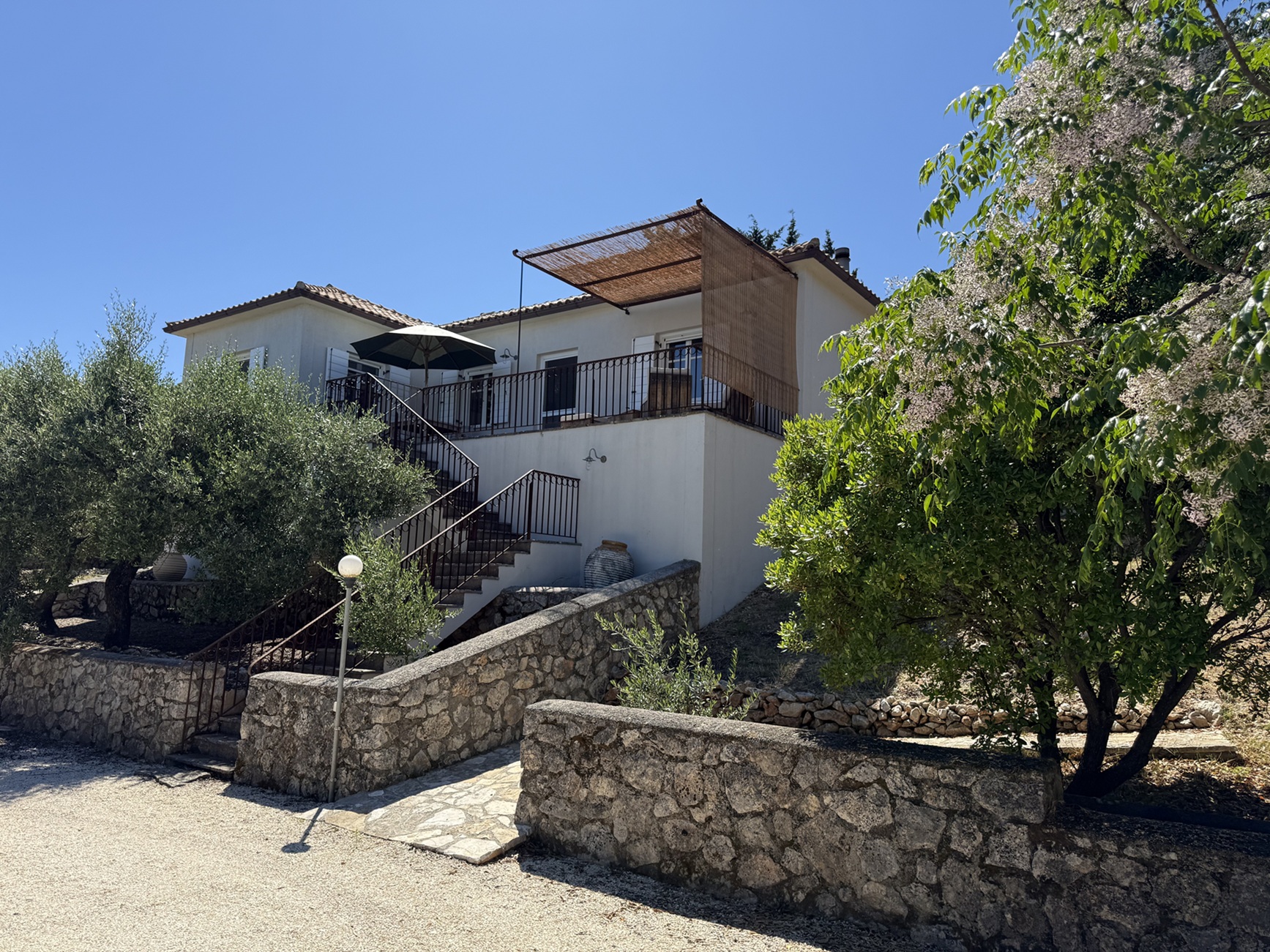 Road view of house for sale in Ithaca Greece, Stavros