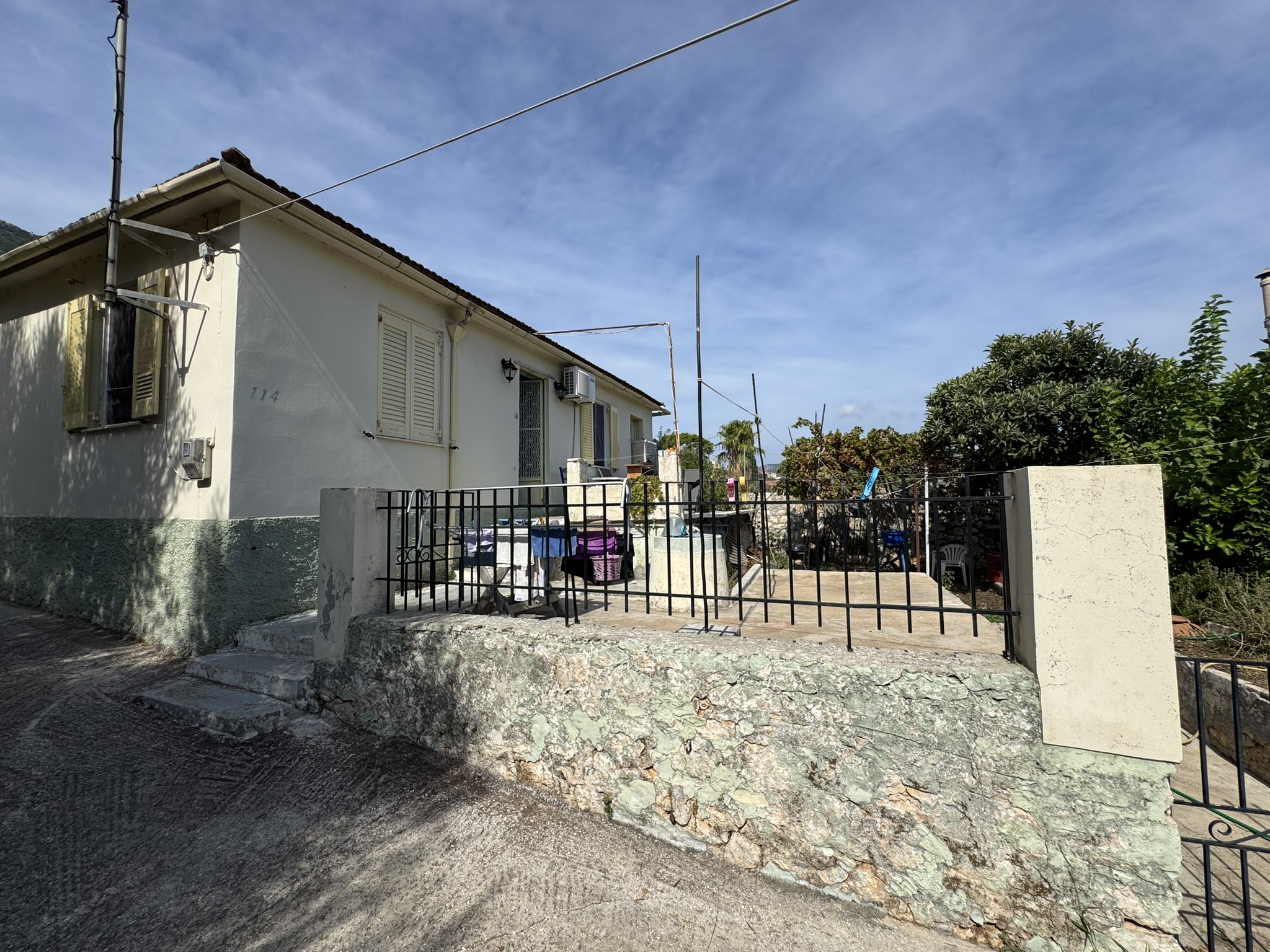 Road view of house for sale in Ithaca Greece, Vathi