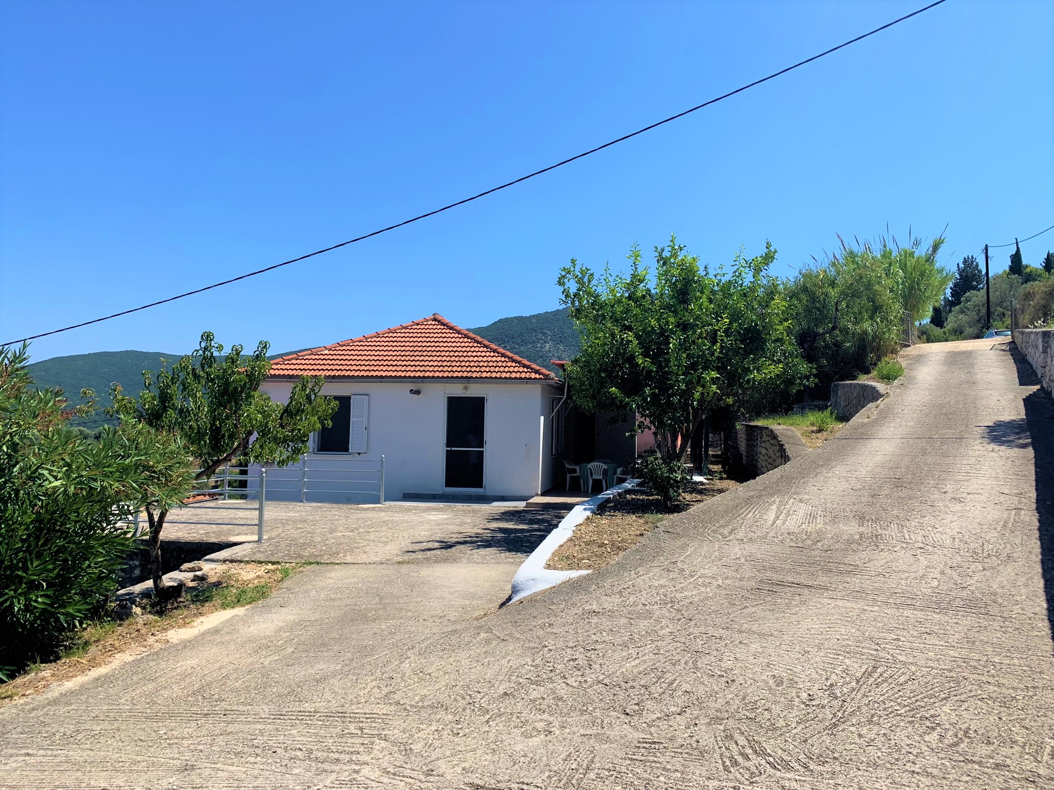 Road view of house for sale in Ithaca Greece, Platrithyas