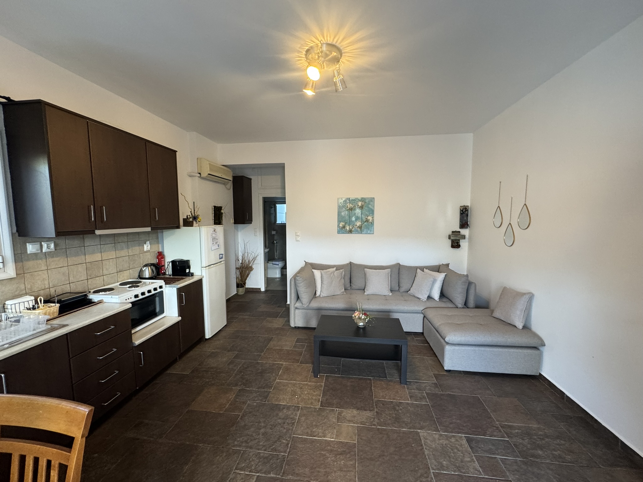 Kitchen and living area in downstairs apartment of house for sale in Ithaca Greece, Vathi