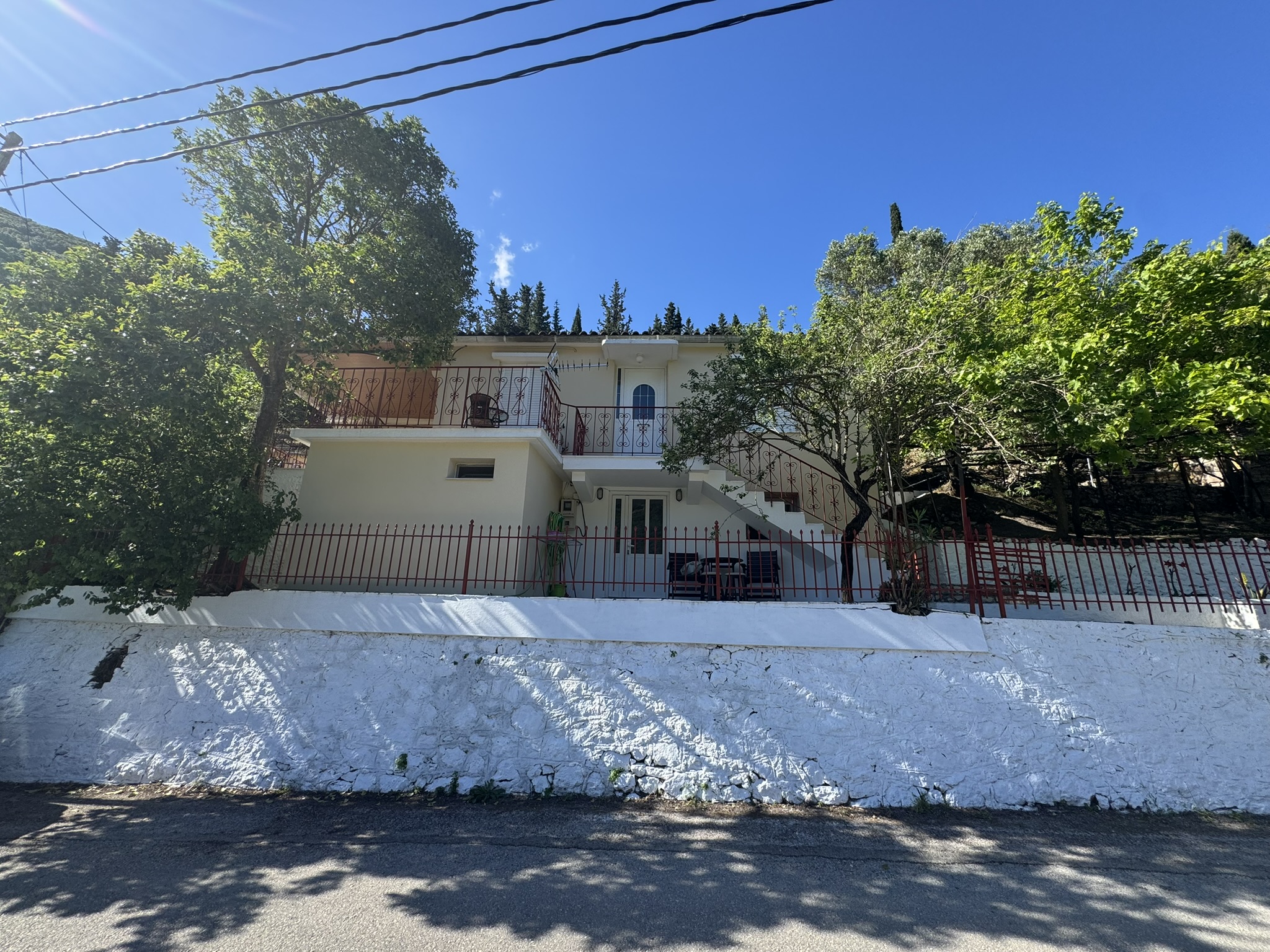 Road view of house for sale in Ithaca Greece Frikes