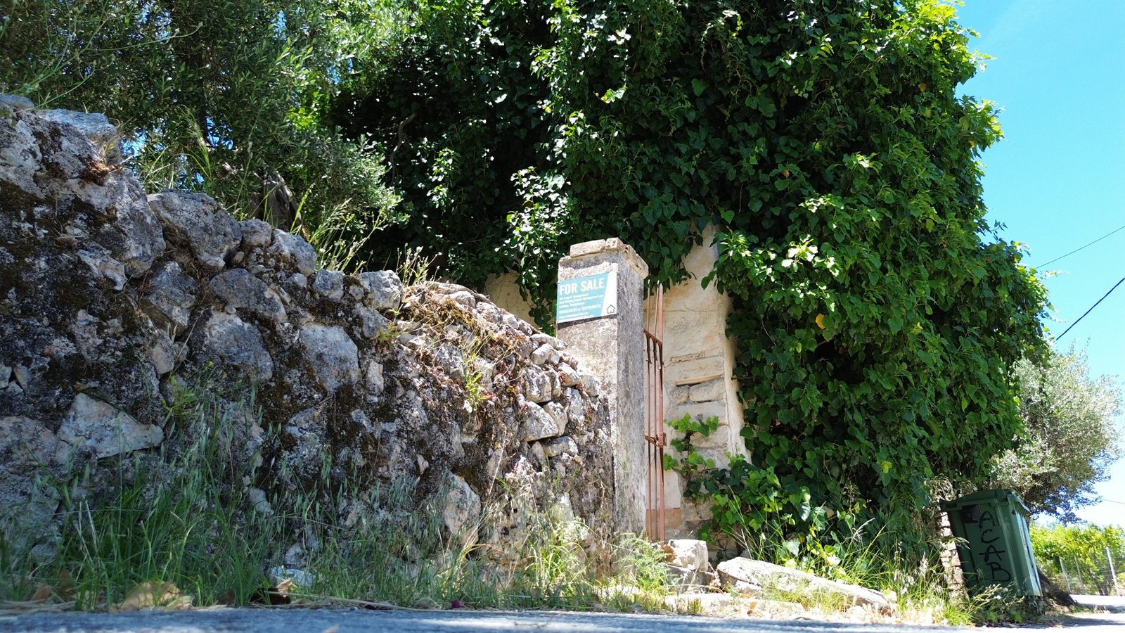 Road view of ruin with land for sale in Ithaca Greece, Kolleri